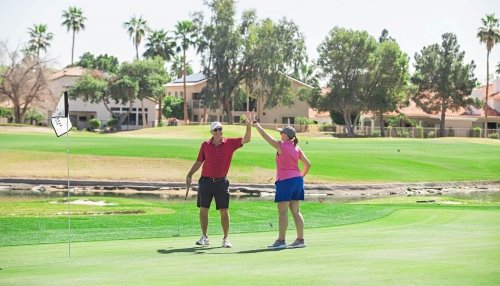 two golfers on the green