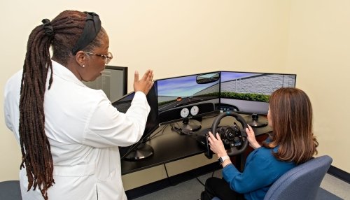 Dr. Wright explains the simulation program to one of the participants.