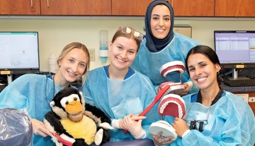 Dental Students pose with animals and props