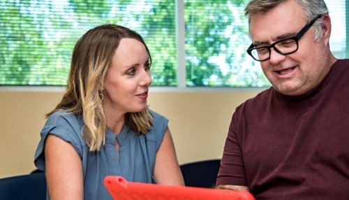 Therapists helps man communicate