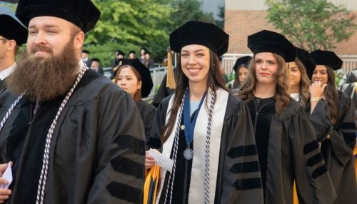students process into the auditorium