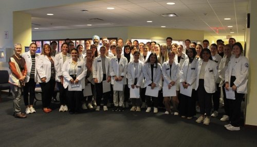 Large group of Physical Therapy students, faculty, and staff, prior to the interdisciplinary activity.