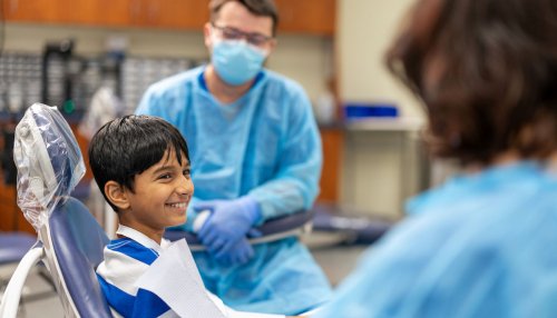 Child sits in dental chair awaiting treatment