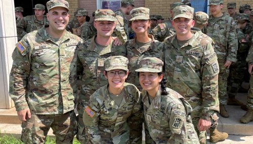 MWU student pose for photo while in military gear