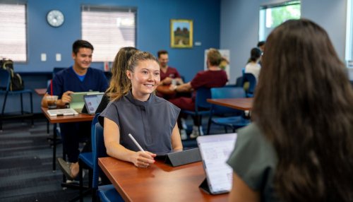 Two students sit at coffee shop