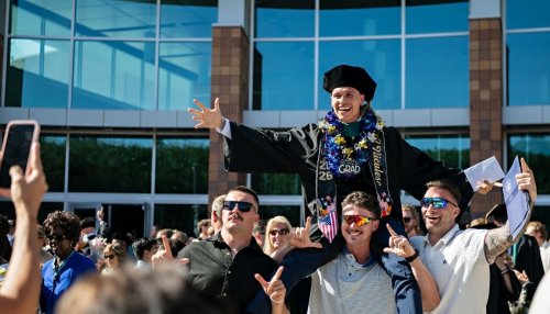grads celebrating outside with friends