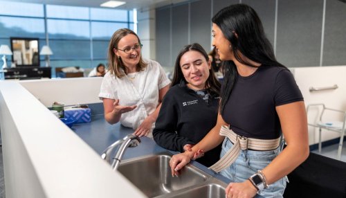 OT students practice helping patients in the kitchen at the Downers Grove, IL campus.