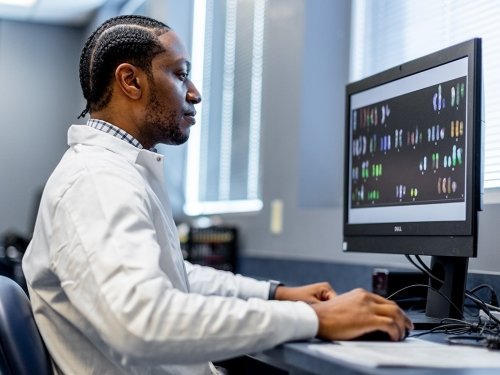 Precision Medicine student learning on lab equipment