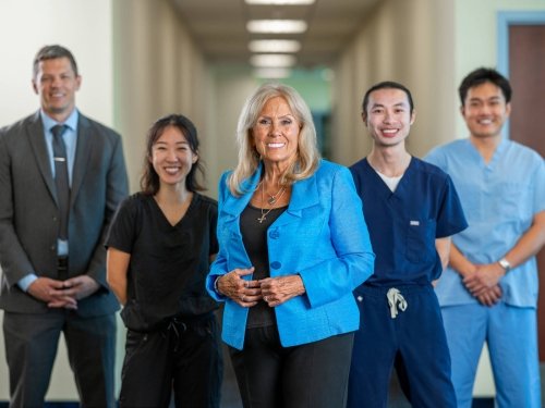 Midwestern University Nursing team and students in front of a hallway.