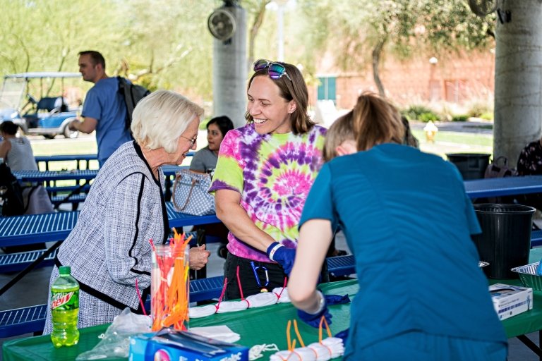 Dr. Kathleen Goeppinger and students at tie-dye event.