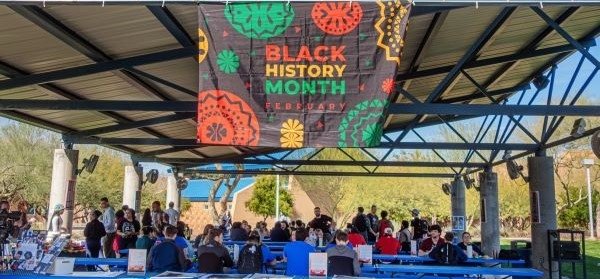 Students gathered outside eating barbecue.