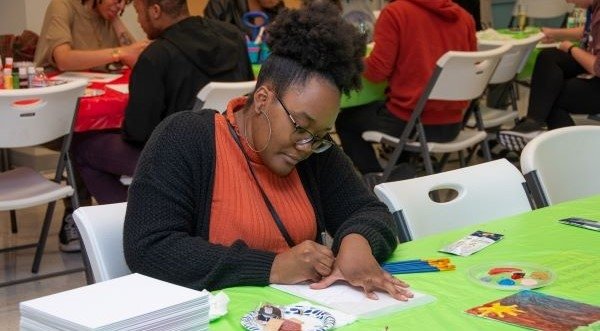 Student using pencil to trace on paper.