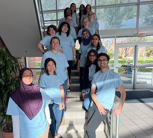 Brain Bee Volunteers standing on the stairs for a group photo.