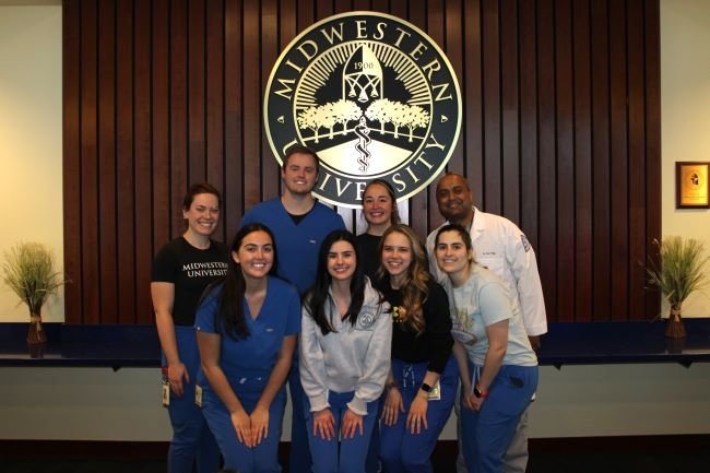 Dental clinic faculty and students pose for a group photo.