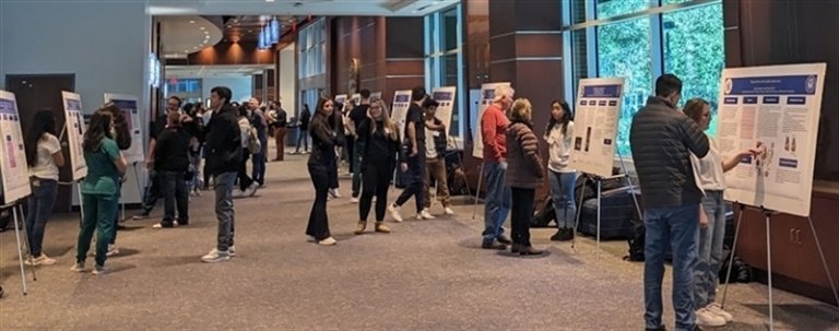 Students presenting their posters to visitors for the CCOM Mini Medical School.