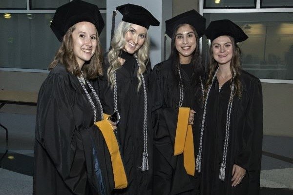 Graduates pose for a picture together.