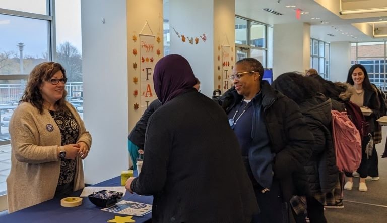 Students stand in line to learn more about the first-generation experience. 