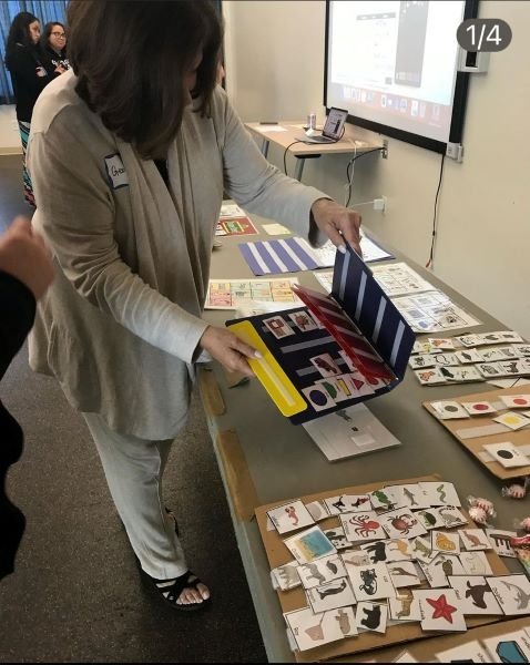 Local educators look over supplemental classroom materials that assist children with autism.