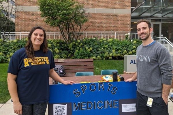 Sports Medicine Club members pose by their club poster. 