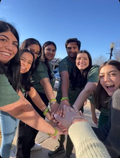 Students put their hands together in solidarity at the St. Baldrick's event.