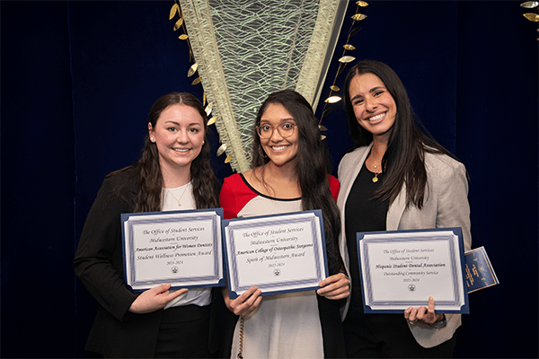 Students display their organization award certificates.