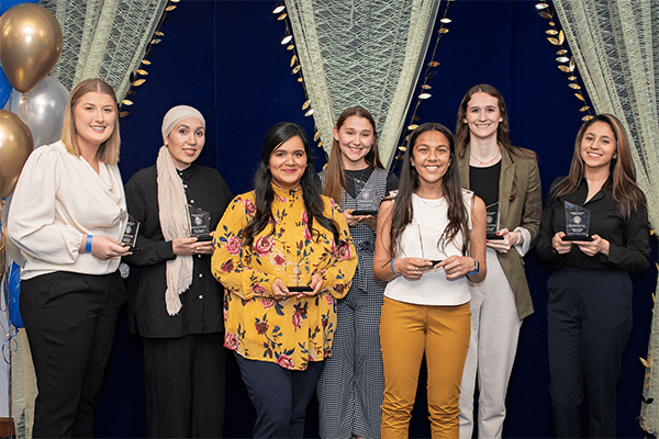 Students display their plaques.