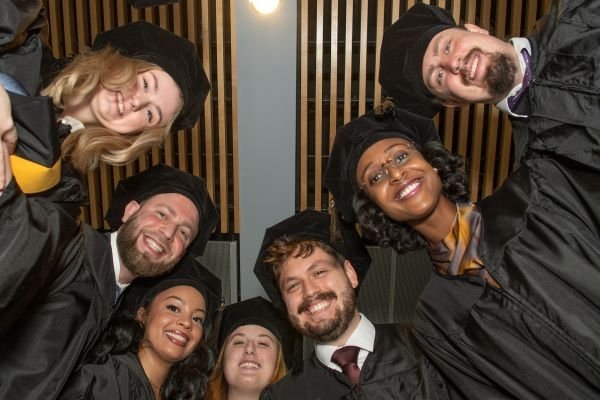 Graduates gather at Spring 2023 commencement in a half circle.