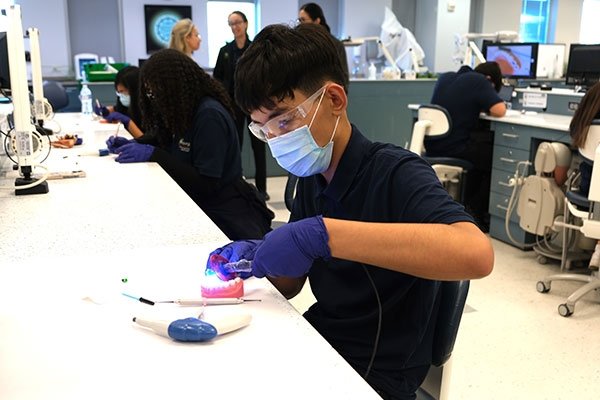 Pendergast Student working on fake set of teeth