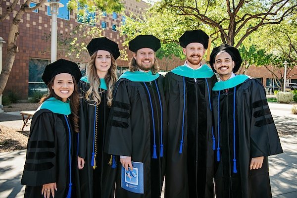 Optometry graduates stand for a group photo