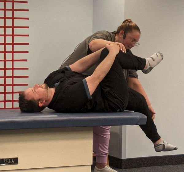 Alyssa Bowen and Ryan Schultz demonstrate an OMM lower extremity movement for the residents to simulate. 