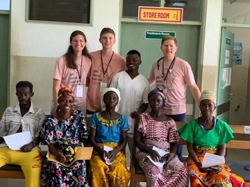 Dr. Boggess and his wife Amelia- at a school in Uganda, working with a non-profit called Days for Girls International.