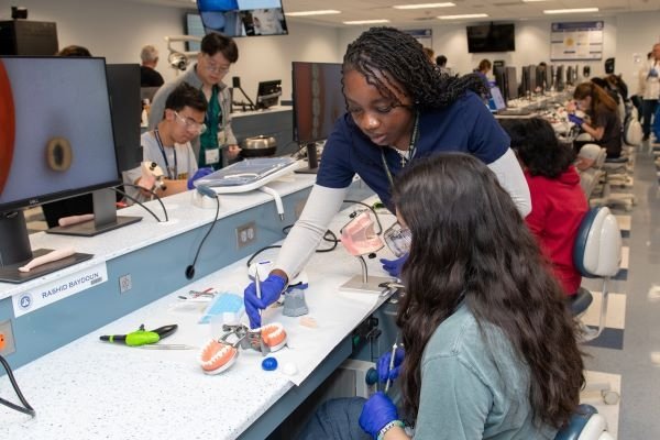 Student mentors assist students during the dentistry session.