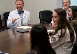 Jason Radke, M.M.S., PA-C, meets with students to discuss community health issues.