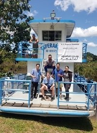 Jessica Denton M.M.S., PA-C (far left) arrives via boat to provide medical care in Peru.