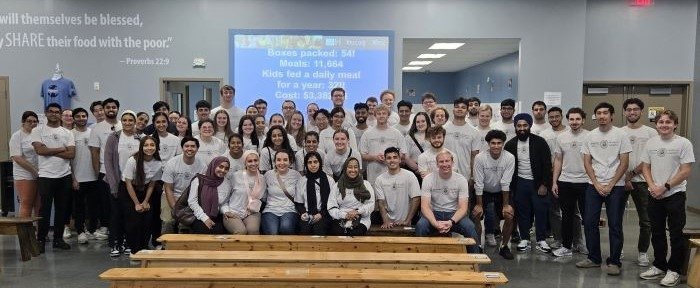 CCOM students in a group photo at Feed My Starving Children.