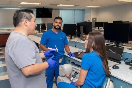 Mario Ramos, D.D.S., M.S., Director of Preclinical Faculty, College of Dental Medicine-Illinois collaborates with students.