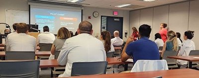 AZ Pilot program participants watch a presentation about the national standardized evaluation.