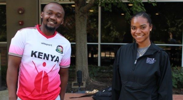 Students stand before the Black Student Alliance table. 