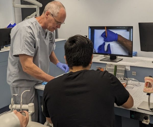 High school students are assisted with dental labs.