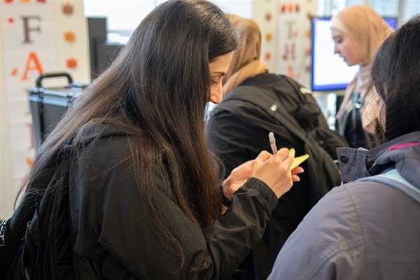 First Generation Honor student writing her strengths on a star.