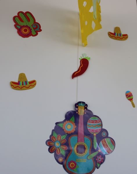 Decor from Hispanic Heritage Month includes a guitar and a sombrero. 