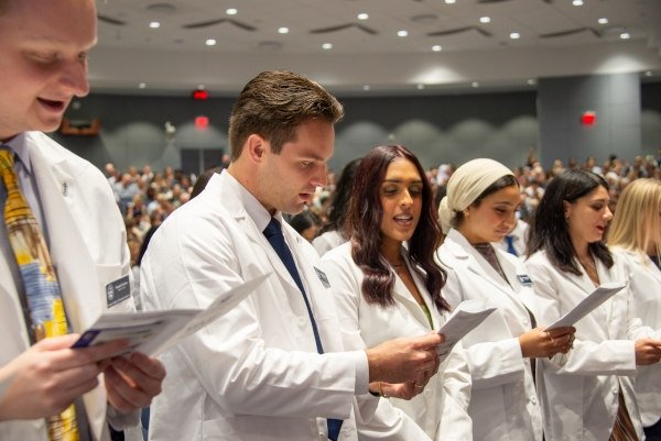 Students recite their oath at the White Coat Ceremony in Downers Grove, IL.