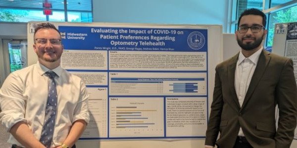 Andrew Baker and Hamza Khan present their research project.