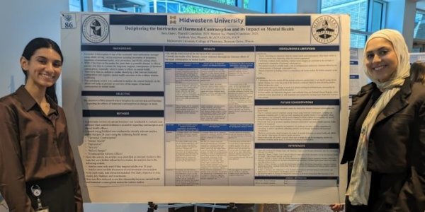 Mariam Isa and Sara Alsawi present their research.