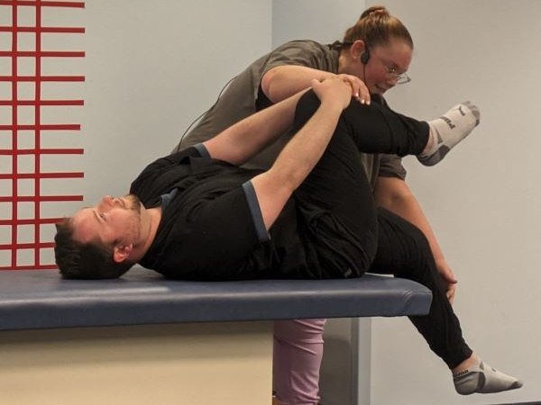 Alyssa Bowen and Ryan Schultz demonstrate an OMM lower extremity movement for the residents to simulate.