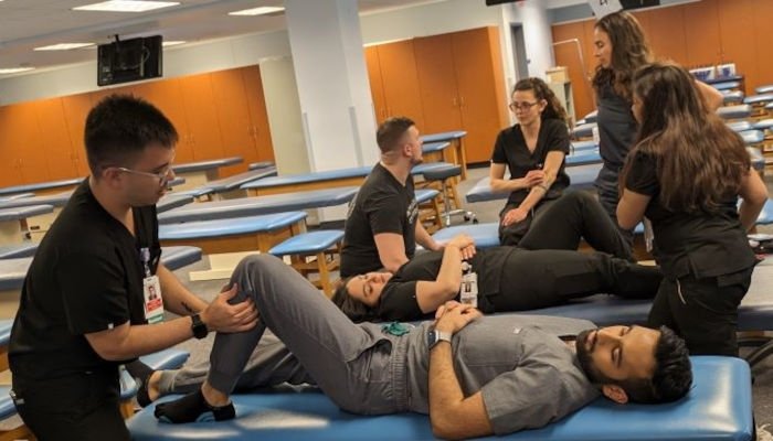 Residents practice OMM techniques.