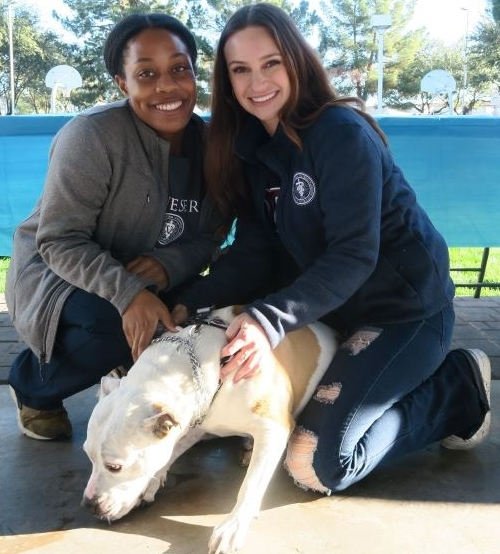 Two students with their dog.