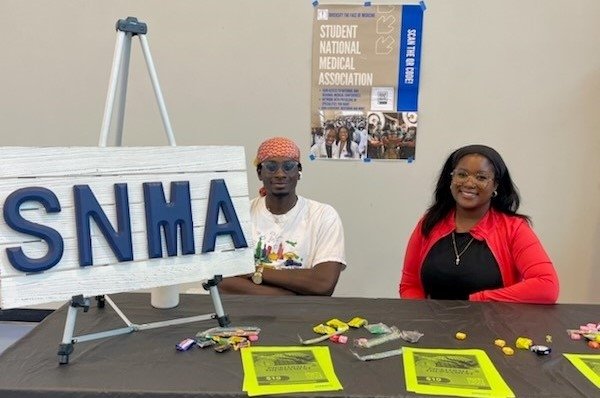 Students at the Student National Medical Association table share information and treats.