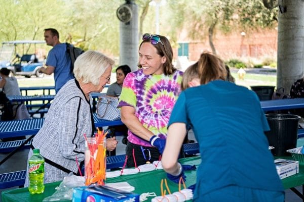 Dr. Kathleen Goeppinger and students at tie-dye event.