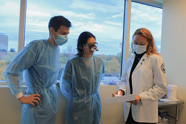 Dental students Jacob Weber (CDMI ’25) and Lilianna Estrada (CDMI ’26) with physical therapy student Erin Lattner (CHS-Downers Grove PT ’25).